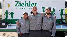 three z-team members in front of Ziehler sign