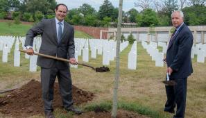 Andrew Ziehler with shovel at cemetery