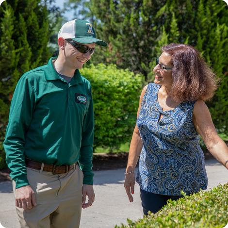 woman talking to lawn technician